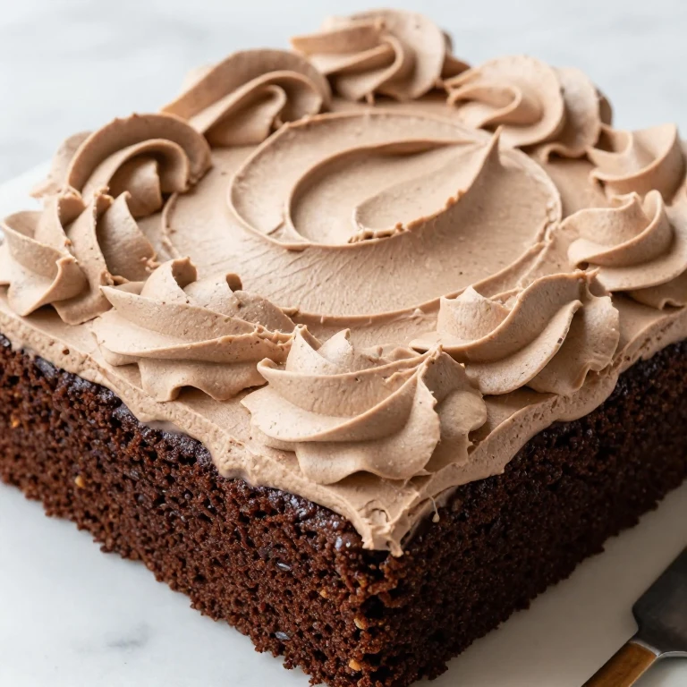Classic fudgy sheet cake with fluffy chocolate frosting and rustic swirls