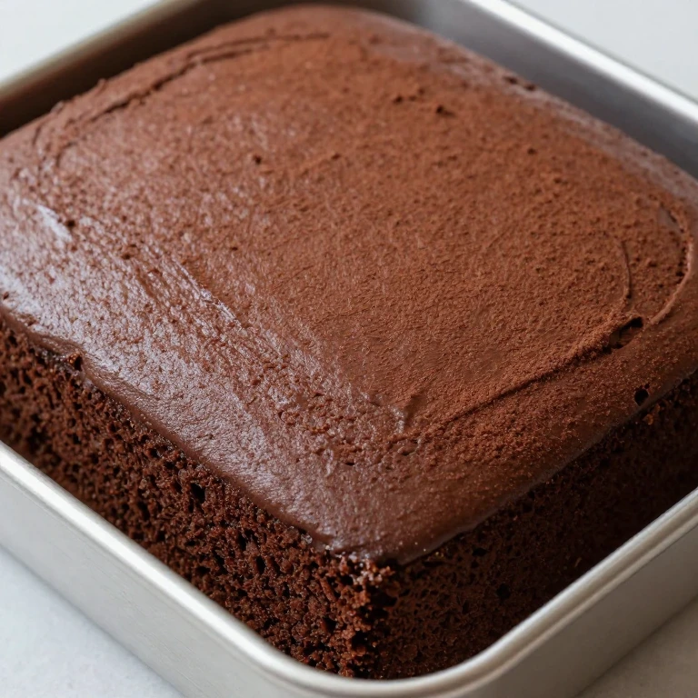 Unfrosted chocolate cake, dense moist texture, ready for frosting