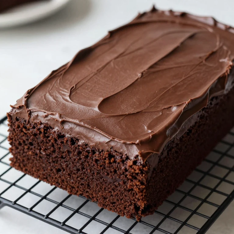 Rich dark chocolate fudge sheet cake with dense moist crumb structure