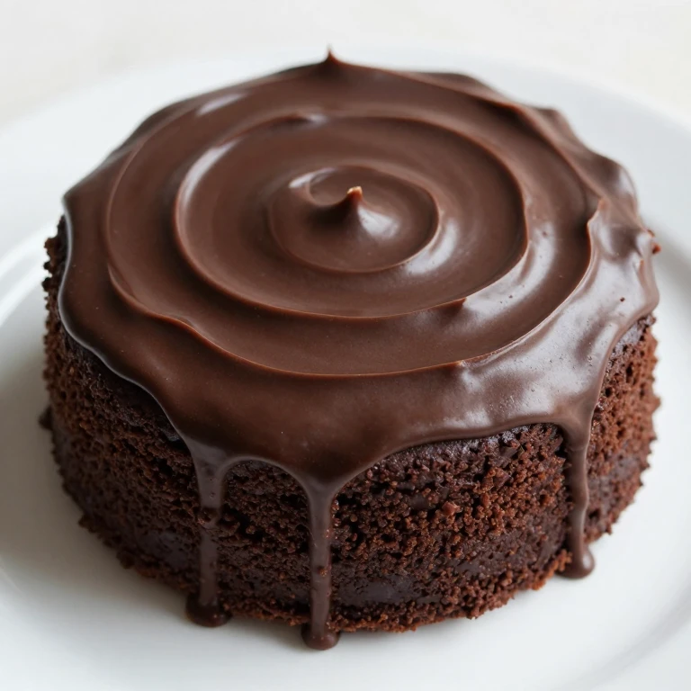 Chocolate fudge sheet cake with glossy dark frosting on white plate