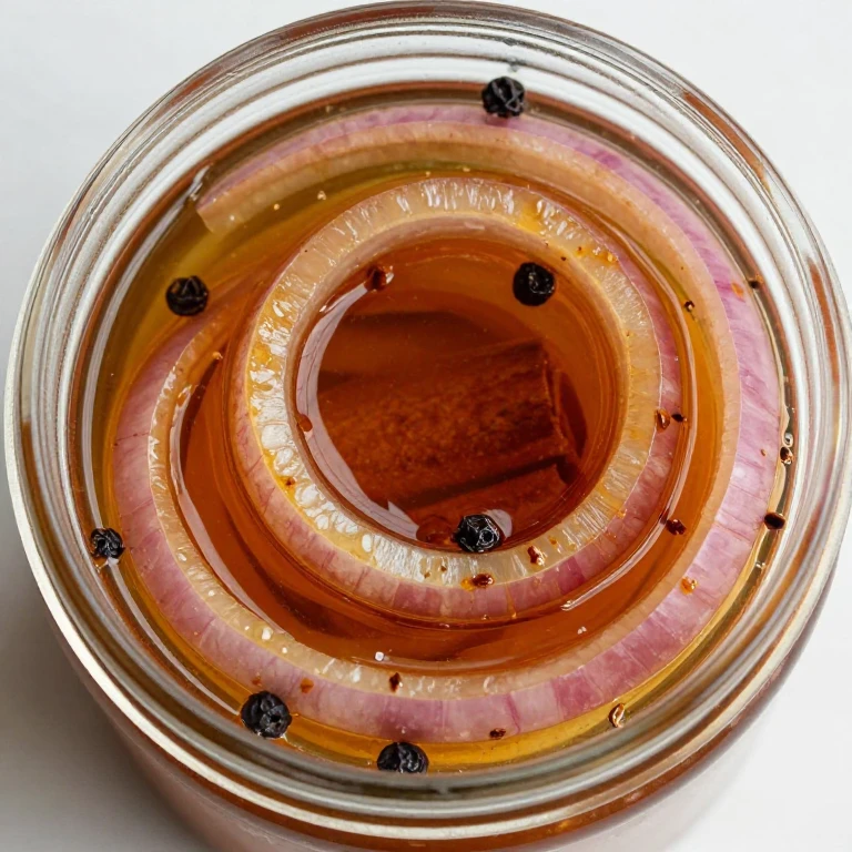Maple honey sweet pickled onions with cinnamon sticks and allspice berries visible