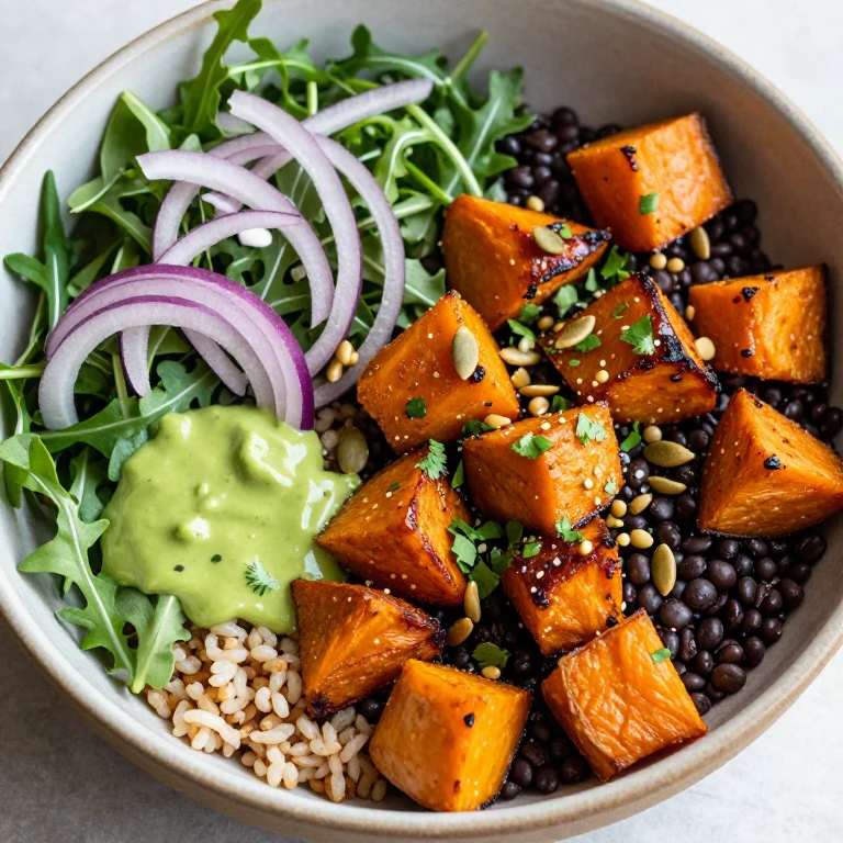 Roasted sweet potato and black lentil bowl with arugula and pumpkin seeds