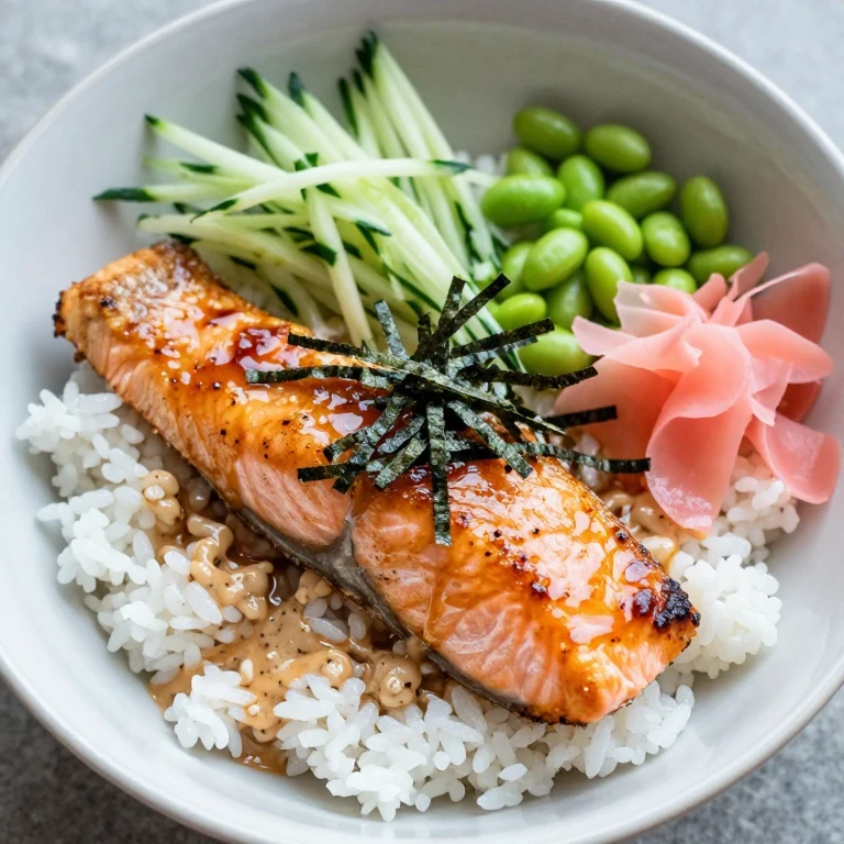 Miso-glazed salmon bowl with cucumber, edamame, pickled ginger, and nori