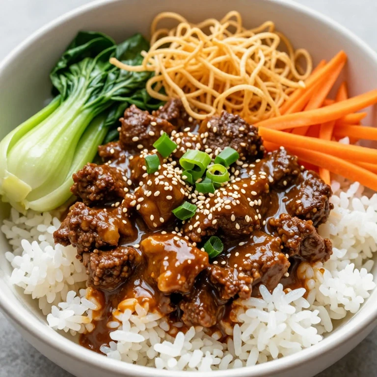 Ginger-garlic beef bowl with crispy rice noodles and sesame