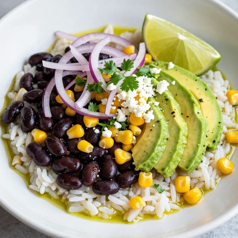 Black bean and corn bowl with avocado, cotija, and lime wedges