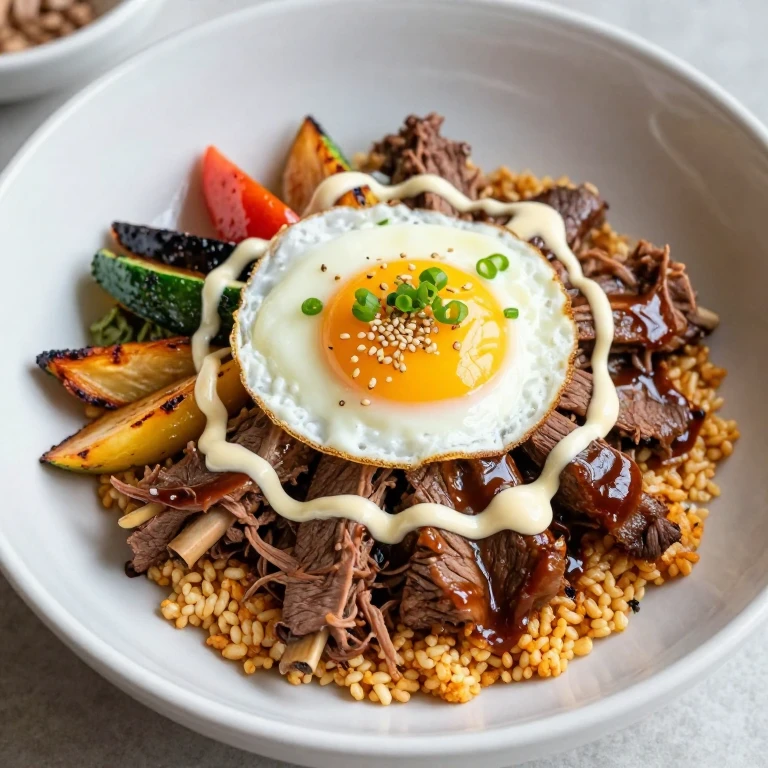Beef short rib bibimbap with gochujang aioli, roasted vegetables, fried egg, sesame seeds