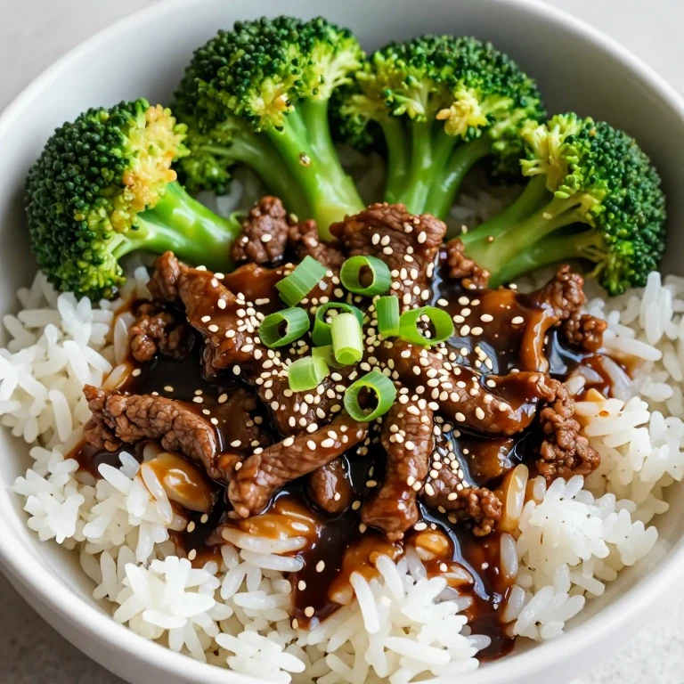 Ginger-soy beef and broccoli rice bowl with sesame seeds and green onions