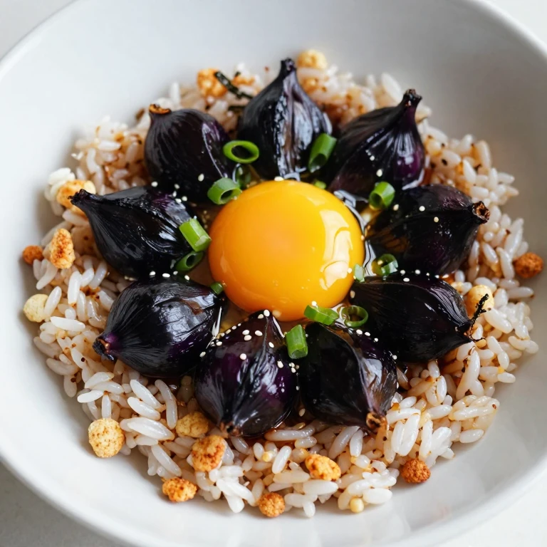 Black garlic and egg yolk bowl with rice, soy, and crispy nori