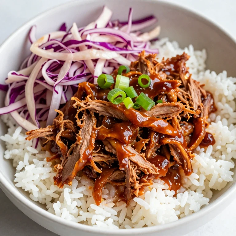 Pulled pork rice bowl with pickled cabbage slaw and green onions