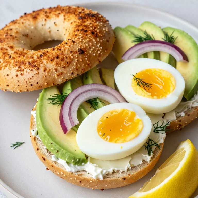 Everything bagel with cream cheese, avocado, and soft-boiled egg halves