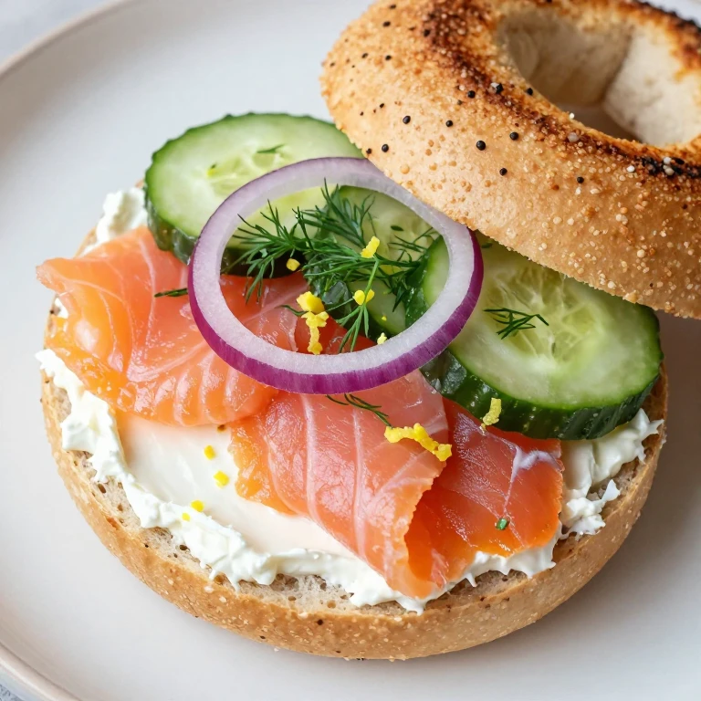 bagel sandwich with smoked salmon, cream cheese, dill, and cucumber